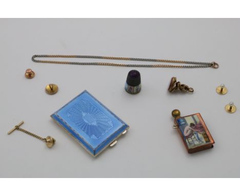 A MIXED LOT:- A late 19th century French "naughty nineties" enamelled copper spark striker, a blue enamelled book match holde