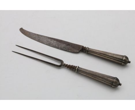 AN EARLY 18TH CENTURY GERMAN MOUNTED STEEL KNIFE AND FORK with reeded tapering handles, decorated with formal strapwork, the 