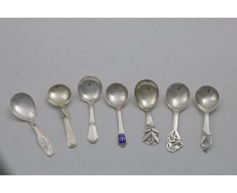SEVEN 20TH CENTURY DANISH CADDY SPOONS of mixed designs, including one with an enamelled terminal;  the largest one 4.4"  (11