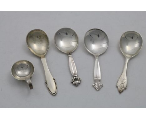 BY GEORG JENSEN:- Four 20th century Danish caddy spoons and a salt with a hammered finish; the latter 2.1"  (5.3 cms) long;  