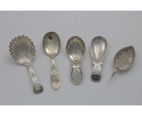 A GEORGE III LEAF CADDY SPOON with repousse-work grapes in the bowl, a Victorian caddy spoon with a beaded lug handle, two an