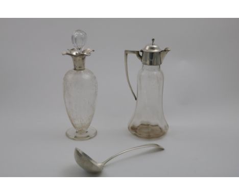 AN EDWARDIAN MOUNTED GLASS CLARET JUG with an angular handle, by William Hutton &amp; Sons Ltd., Birmingham 1907, a mounted g