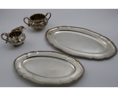 A GRADUATED PAIR OF GEORGE V MEAT DISHES of shaped oval outline with gadrooned borders by Mappin &amp; Webb, Sheffield 1918, 