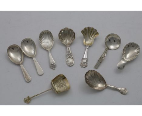 A VICTORIAN CADDY SPOON with a fluted, fan-shaped bowl and a grotesque figure terminal, by Hilliard and Thomason, Birmingham 