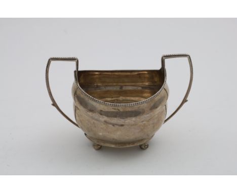 A GEORGE III IRISH PROVINCIAL TWO-HANDLED SUGAR BASIN on ball feet with gadrooned borders, by Carden Terry &amp; Jane William