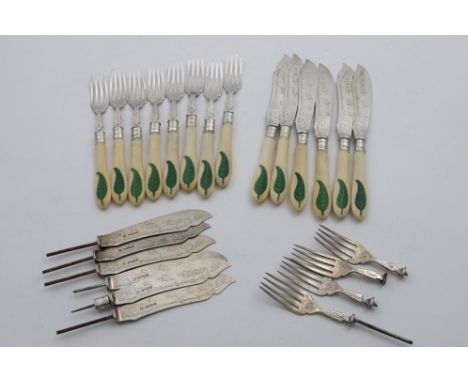 A VICTORIAN SET OF SIX ENGRAVED FISH KNIVES AND EIGHT FISH FORKS with ivory handles and a green-stained fern floral carved in