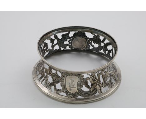A GEORGE III IRISH DISH RING pierced and chased with figures, architecture, birds, flowers and a dog, crested, maker's mark "