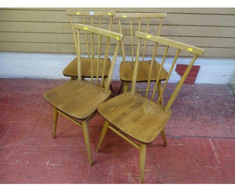 Set of four light wood Ercol stick back chairs