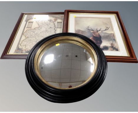 A circular contemporary port hole mirror together with a framed map of Northumberland and a further framed print of a stag.