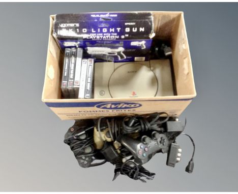 A box of five Playstation games, console, pair of controls and a XK10 light gun 