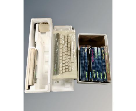 A vintage Acorn Electron computer and keyboard in original packaging with introductory cassettes  