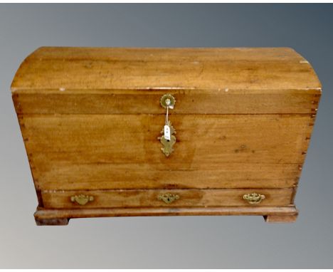 A 19th century domed topped shipping trunk, fitted with a drawer, brass handles and mounts 