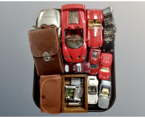 A tray containing diecast model cars, assorted vintage lighters including Ronson, Corona etc and two vintage cameras. 
