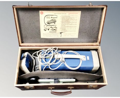 A vintage Hoover vacuum cleaner in case.