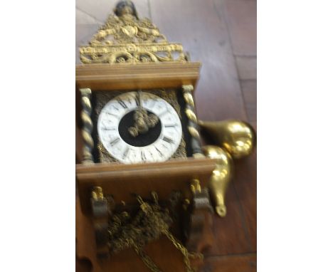 A continental wall clock, signed Wuba, silvered dial with Roman and Arabic numerals, with Nu Elck Syn Sin above with Atlas sh