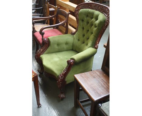 A button back 20thC mahogany arm chair carved with foliage