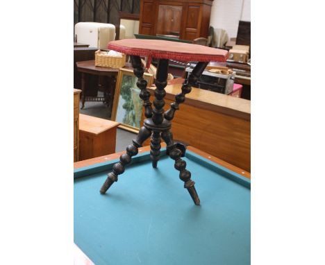 A 19thC and later ebonised octagonal tripod table on bobin turned legs, 46cm in diameter.