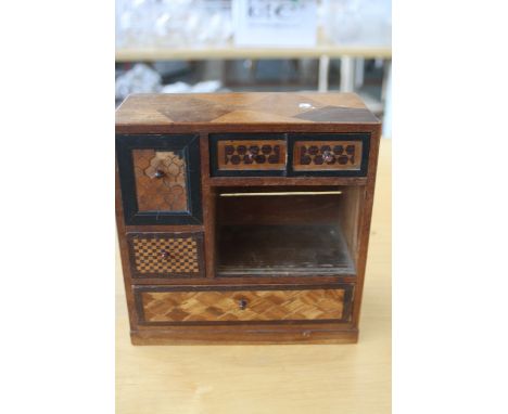 A Victorian specimen wood collectors cabinet, the specimen case with five drawers each inlay with various parquetry, with she