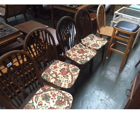 A set of four wheelback chairs, with an Ercol style light elm chair and a stool with padded seat