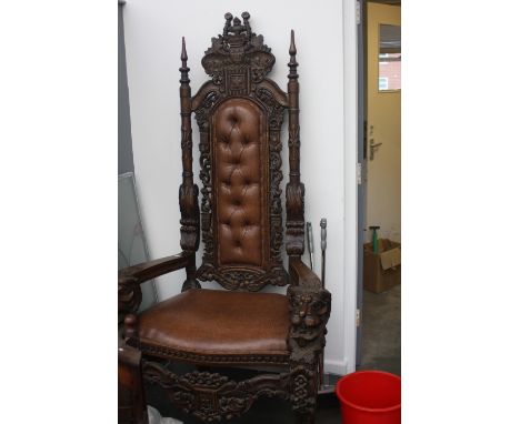 A pair of baronial throne chairs 20th Century,w ith a leafy shaped cresting above an outstretched carved eagle padded leather