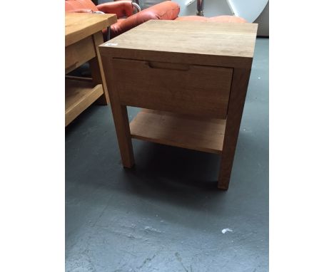 A light oak bedside table with single drawer and undershelf