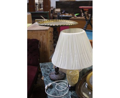 An oriental style carved wood and brass side table depicting draons, 76cm in hight x 50cm, with a chinese style resin side la