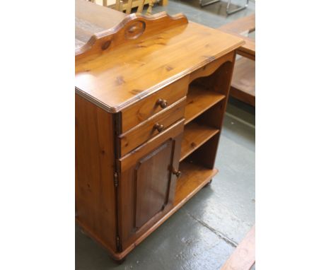 A pine cupboard unit, 2 drawers over a cupboard with 3 shelves, on bun feet, 76cm wide x 94cm high, with a bird based lamp ba
