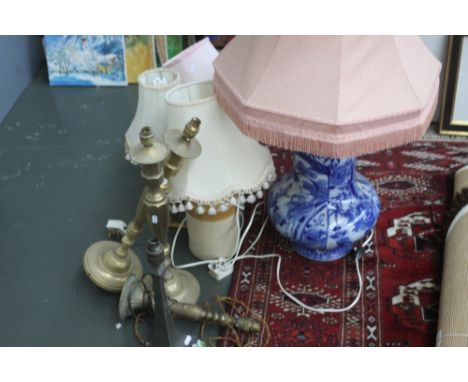 A large Chinese style glazed lamp base with flowers, with three other lamps, one with stoneware base, with a pair of brass la