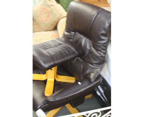 A modern faux leather reclining chair and foot stool