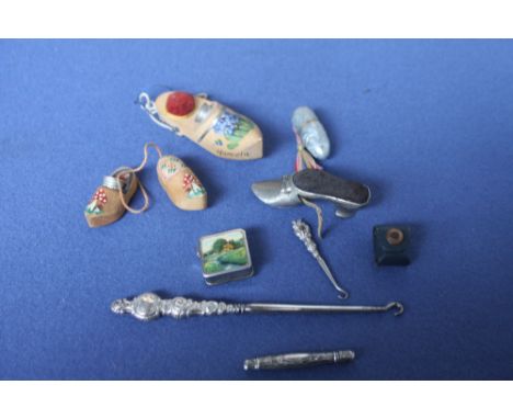A white and gilt metal thimble and thread holder with George VI coronation plaque, a pin cushion and tape measure in the form