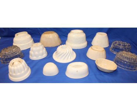 A selection of various ceramic jelly moulds with geometric shapes together with glass jelly moulds etc