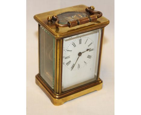 A traditional carriage clock with enamelled rectangular dial in brass rectangular glazed case 