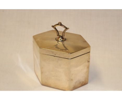 A George V hexagonal silver tea caddy with hinged lid and folding handle, 3¾" long, London marks 1924 