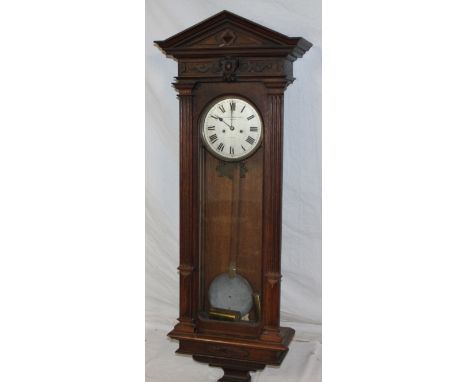 A good quality Vienna-style regulator wall clock by The Goldsmiths & Silversmiths Company of London in carved oak traditional