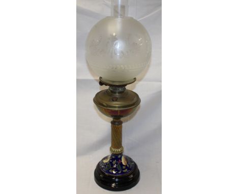 A good quality brass and ceramic oil lamp by Youngs with blue floral ceramic base and etched glass shade 