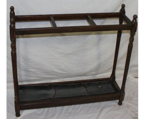 An Edwardian oak rectangular stick stand with turned supports 29½" long 