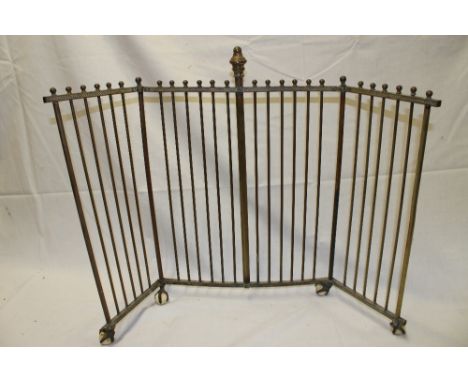 An Edwardian brass three-part folding fire screen with brass and ceramic claw and ball feet 22" high 