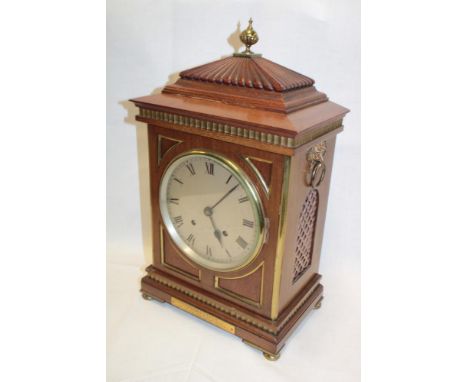 A good quality bracket clock with chiming movement and silvered circular dial in brass mounted mahogany traditional case with