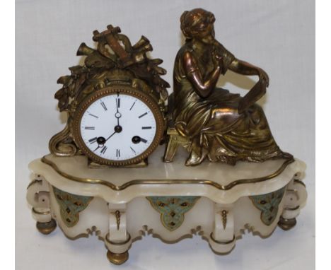 A good quality French mantle clock with circular enamelled dial in gilt brass mounts with seated female figure on brass mount