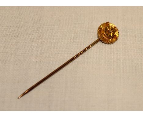 A 10ct gold stick pin set diamond chips (1.5g)