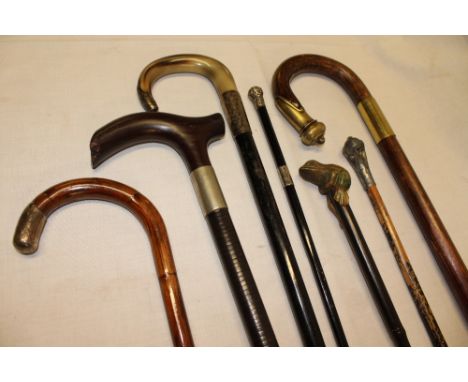 Seven various gentleman's walking sticks and canes including horn mounted walking stick with silver  ferrules, coiled leather