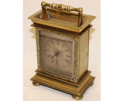 An unusual good quality travelling clock with silvered rectangular dial in brass rectangular glazed case, 5½" high 
