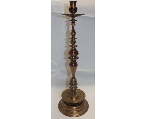 A large Dutch bronze baluster-shaped candlestick on circular spreading base, 21" high