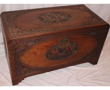 An Eastern carved camphorwood rectangular trunk with decorated panels of sailing ships 38" wide 
