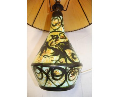 A Cornish Celtic pottery, Newlyn table lamp with mythical creature decoration together with shade