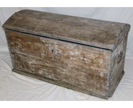 An old pine domed trunk with internal candle box enclosed by a curved hinged lid with iron ring handles, 42" long 