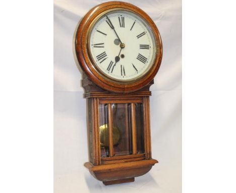 A 1920's wall clock with painted circular dial in polished oak glazed case, 26½" long 