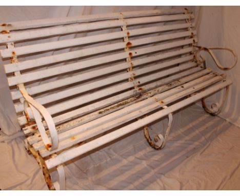 A Victorian painted iron garden bench with wooden slatted supports, 72" long 