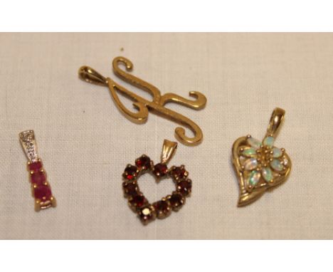 A selection of 9ct gold pendants including opal mounted heart-shaped pendant, garnet mounted pendant etc (5.4g gross)