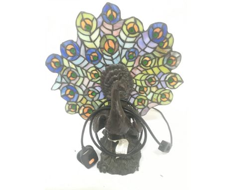 A lead light and simulated bronze table lamp in the form of a Peacock. Height 36cm